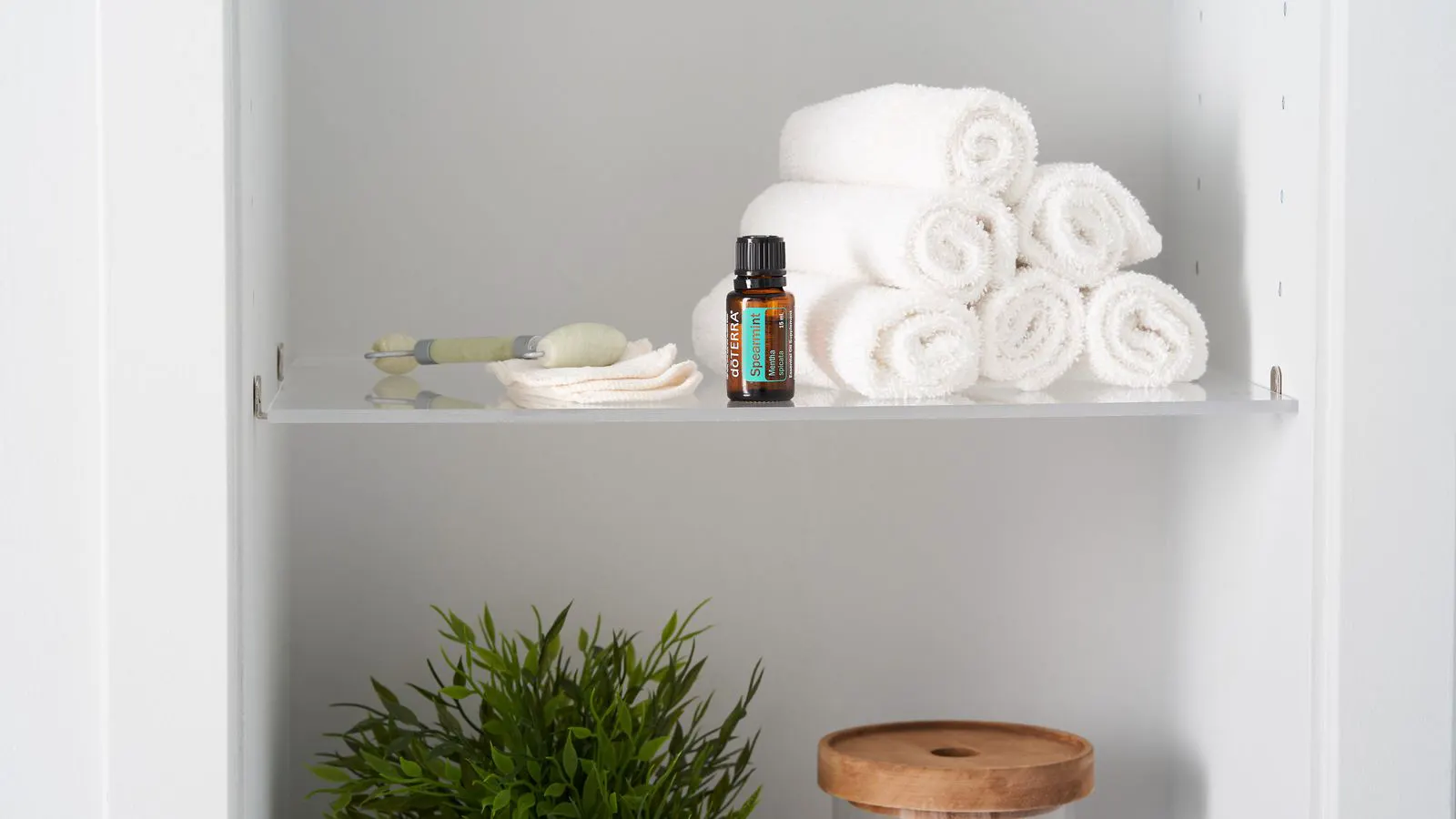 Stack of folded white towels on a metal shelf
