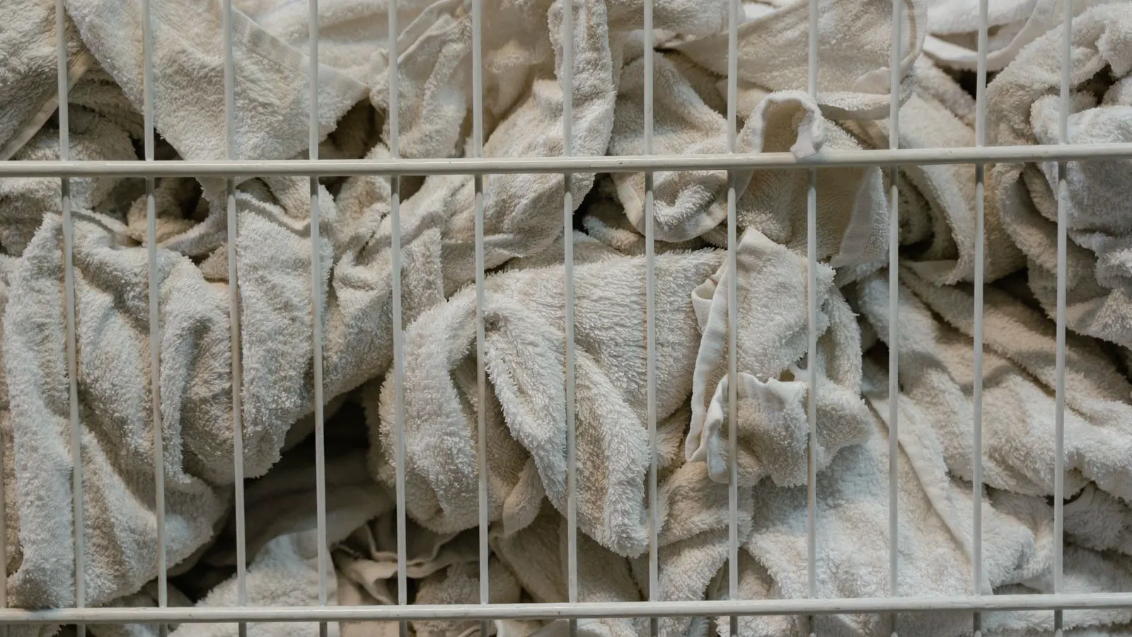 Close up of folded white sheet fabric ready for industrial laundering