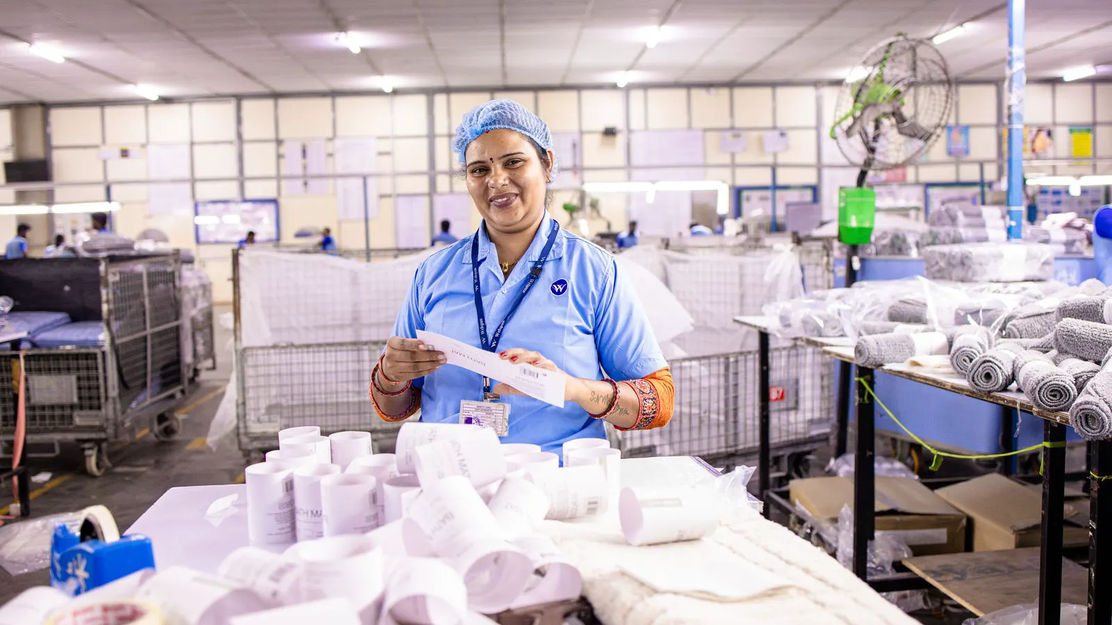 A scanner reading a digital code on a textile swatch during inspection