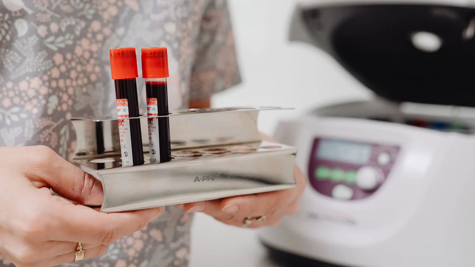 A technician prepares a textile sample for mechanical strength testing