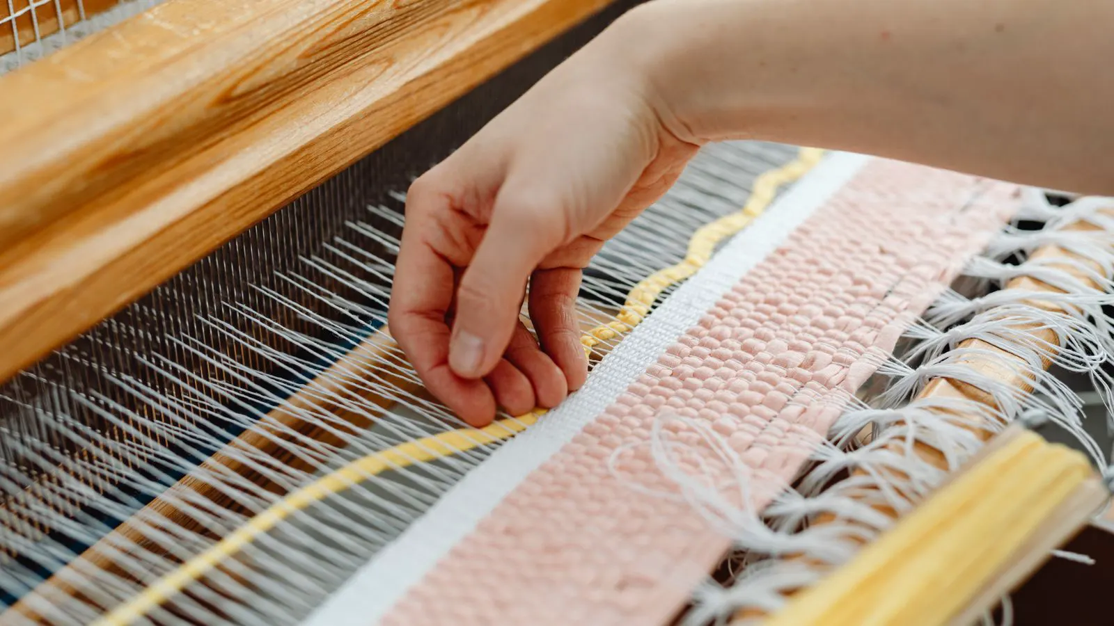 Close-up view of warp threads on a weaving loom for sheet production
