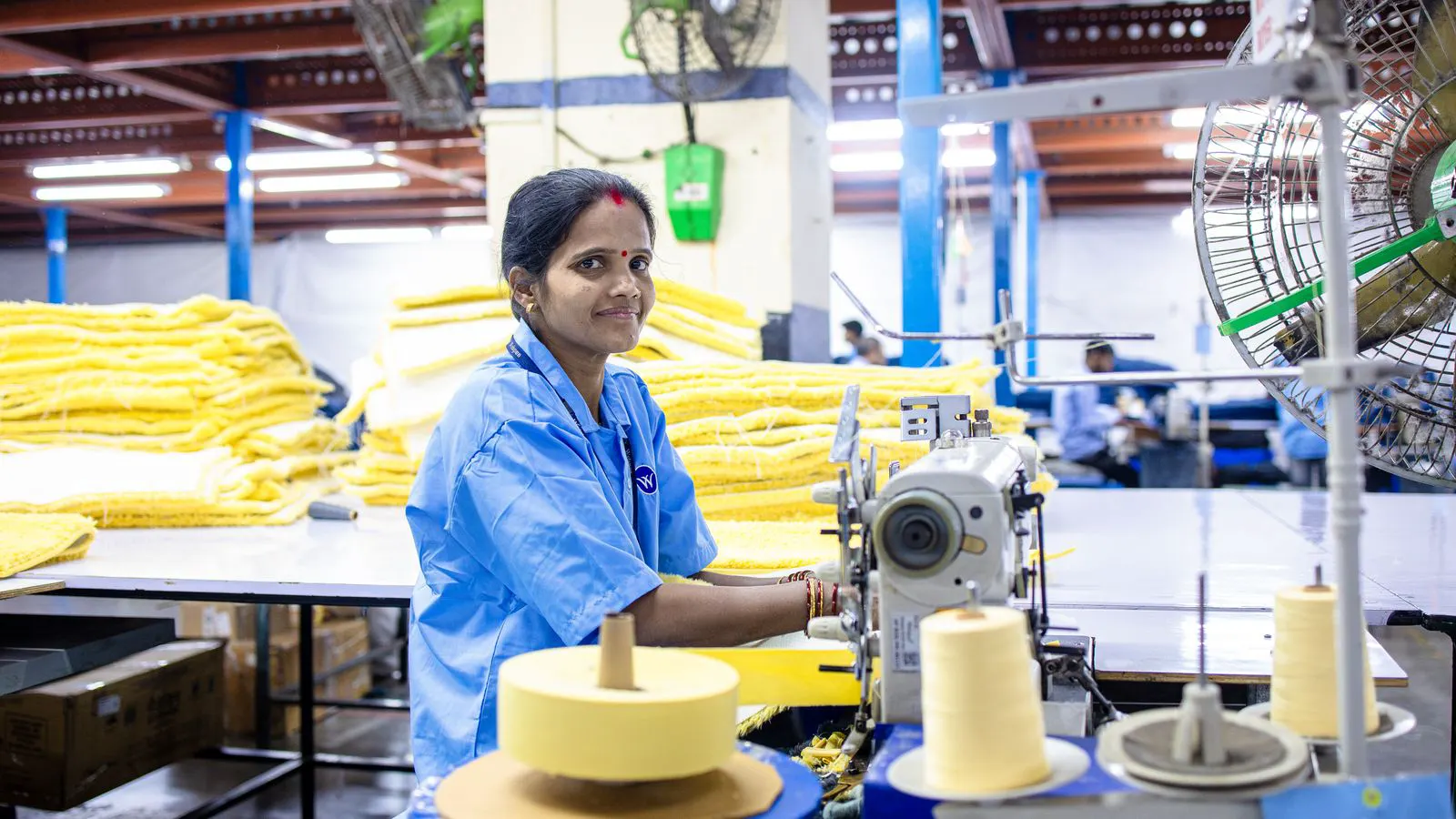 A modern weaving loom producing woven fabric in a textile mill.