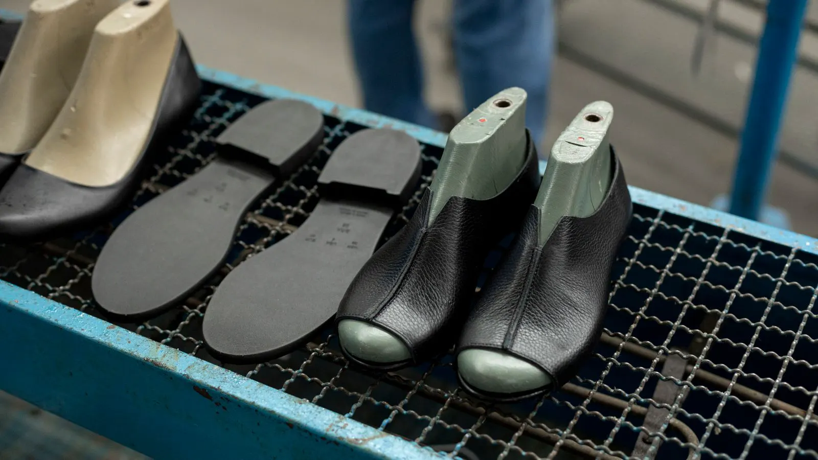A wooden boot last with a heel and toe box on a workbench