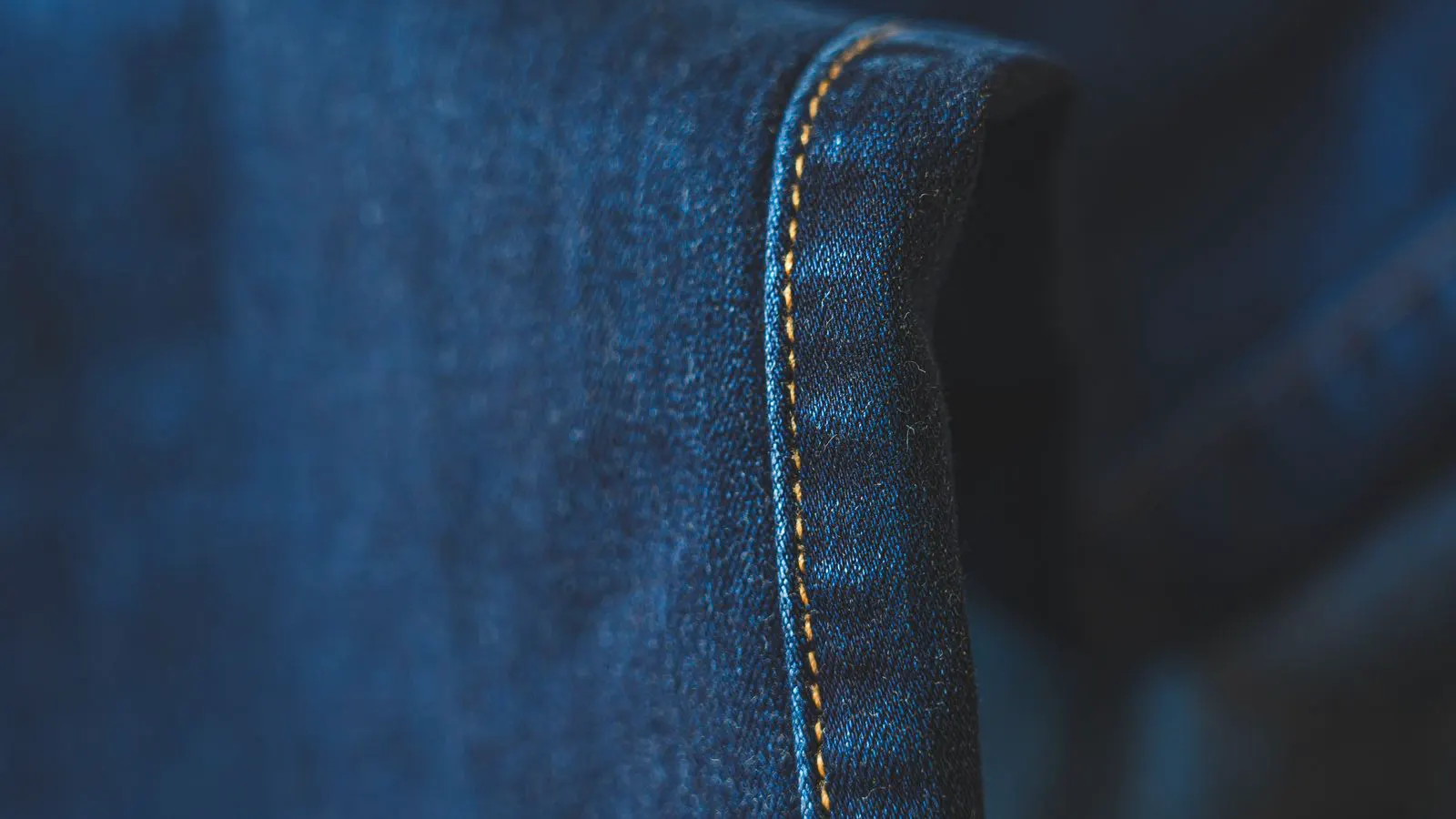 Close up view of flatlock and bar tack stitching on canvas material