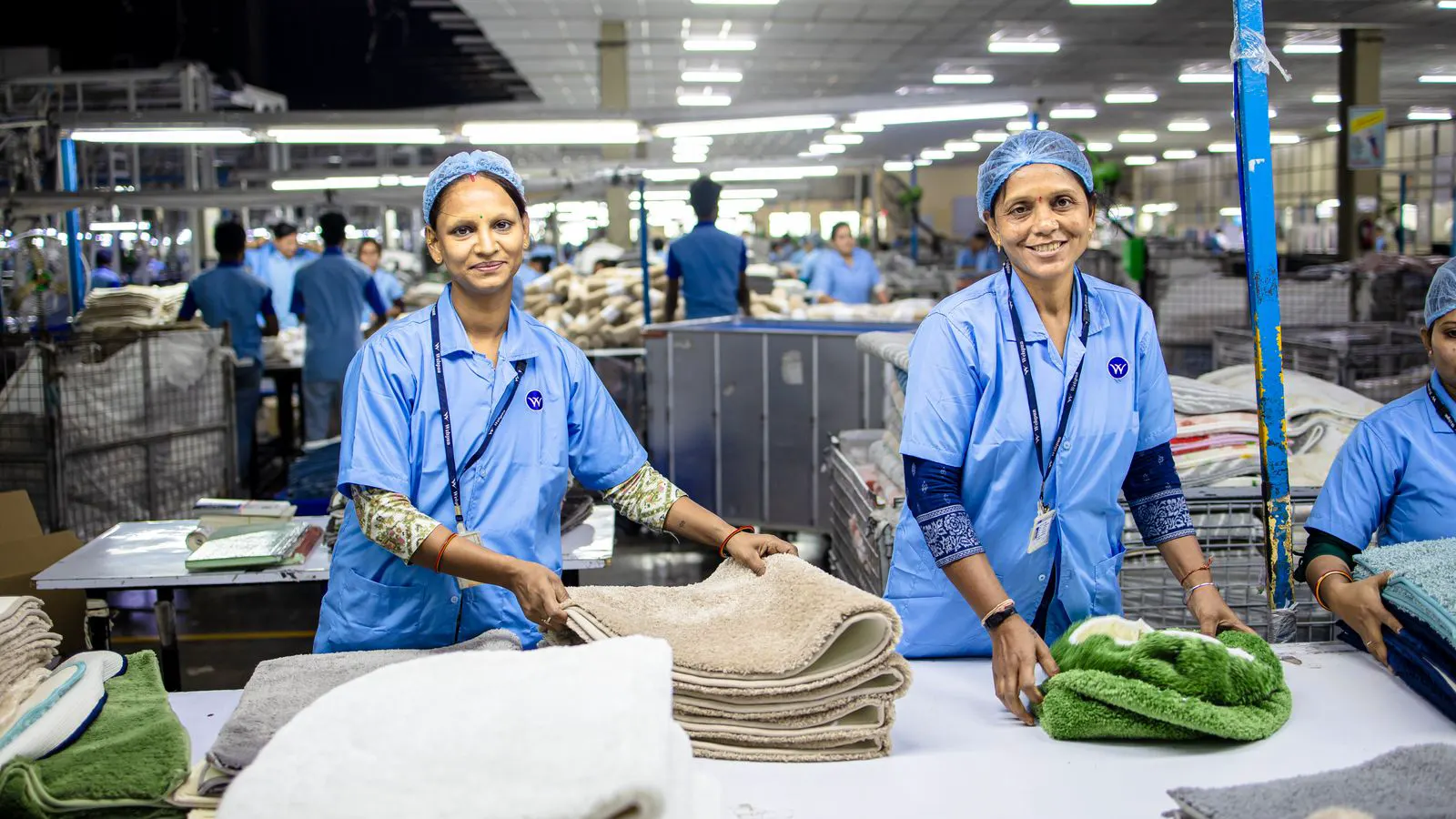 workers assembling luggage shells on a manufacturing line