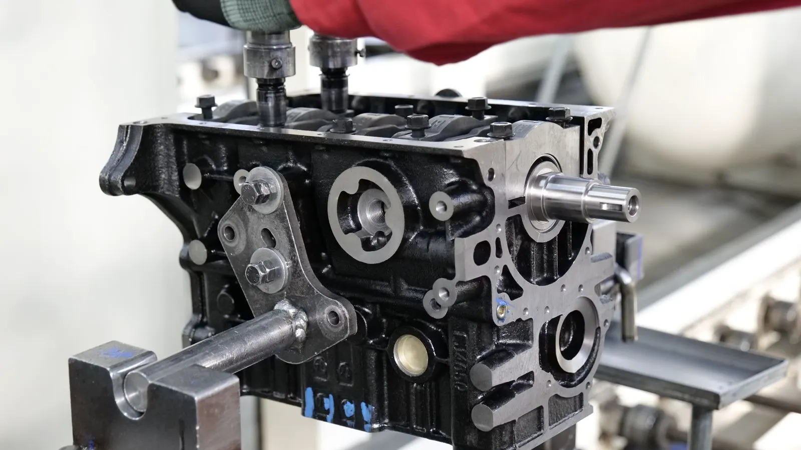 Technician inspecting a cylinder block in a workshop