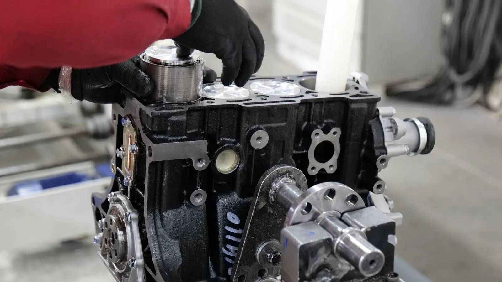Close up of a metal gear assembly on a workbench.