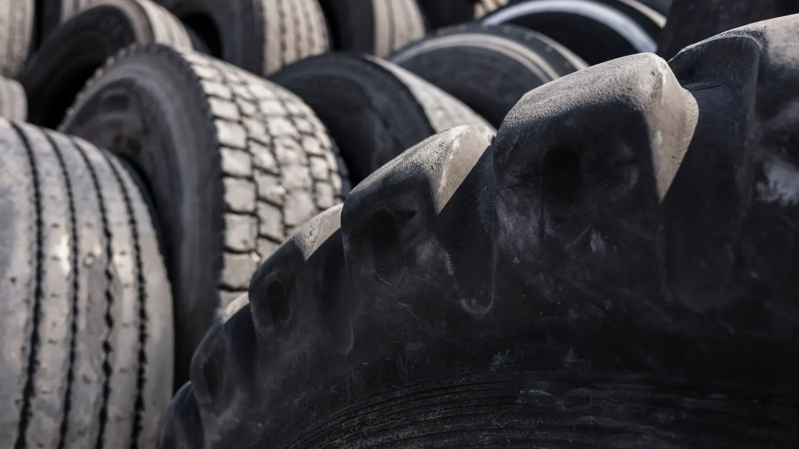 A close-up view of a heavy-duty tire mounted on a bus wheel