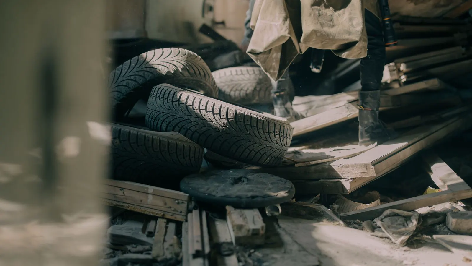 Rows of new passenger tires stacked in a tire warehouse