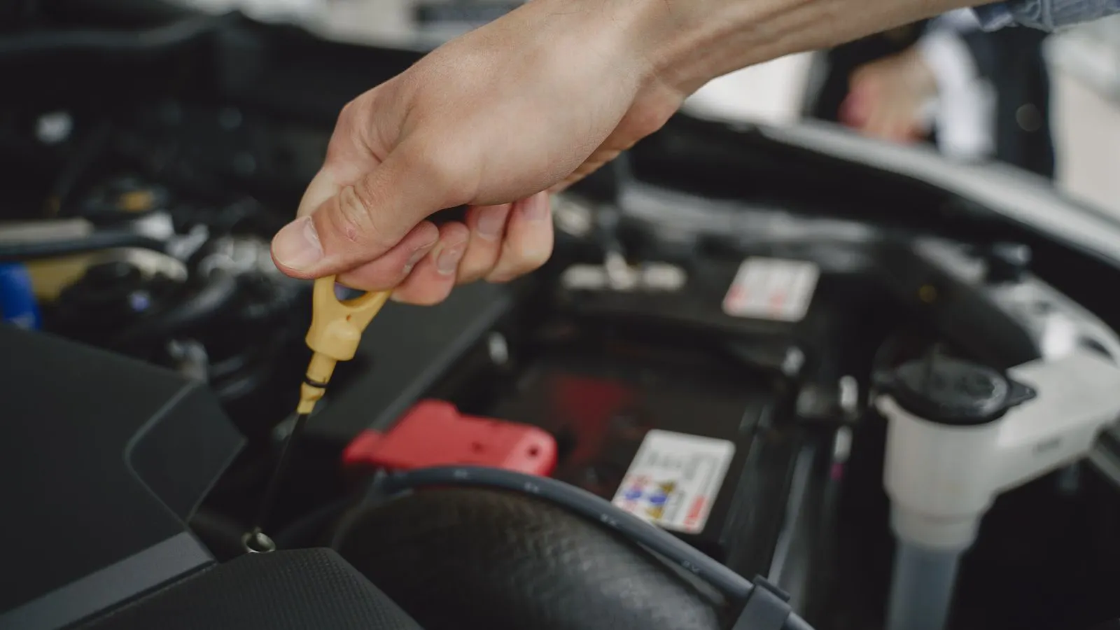 Technician uses a tread gauge to measure passenger tire depth