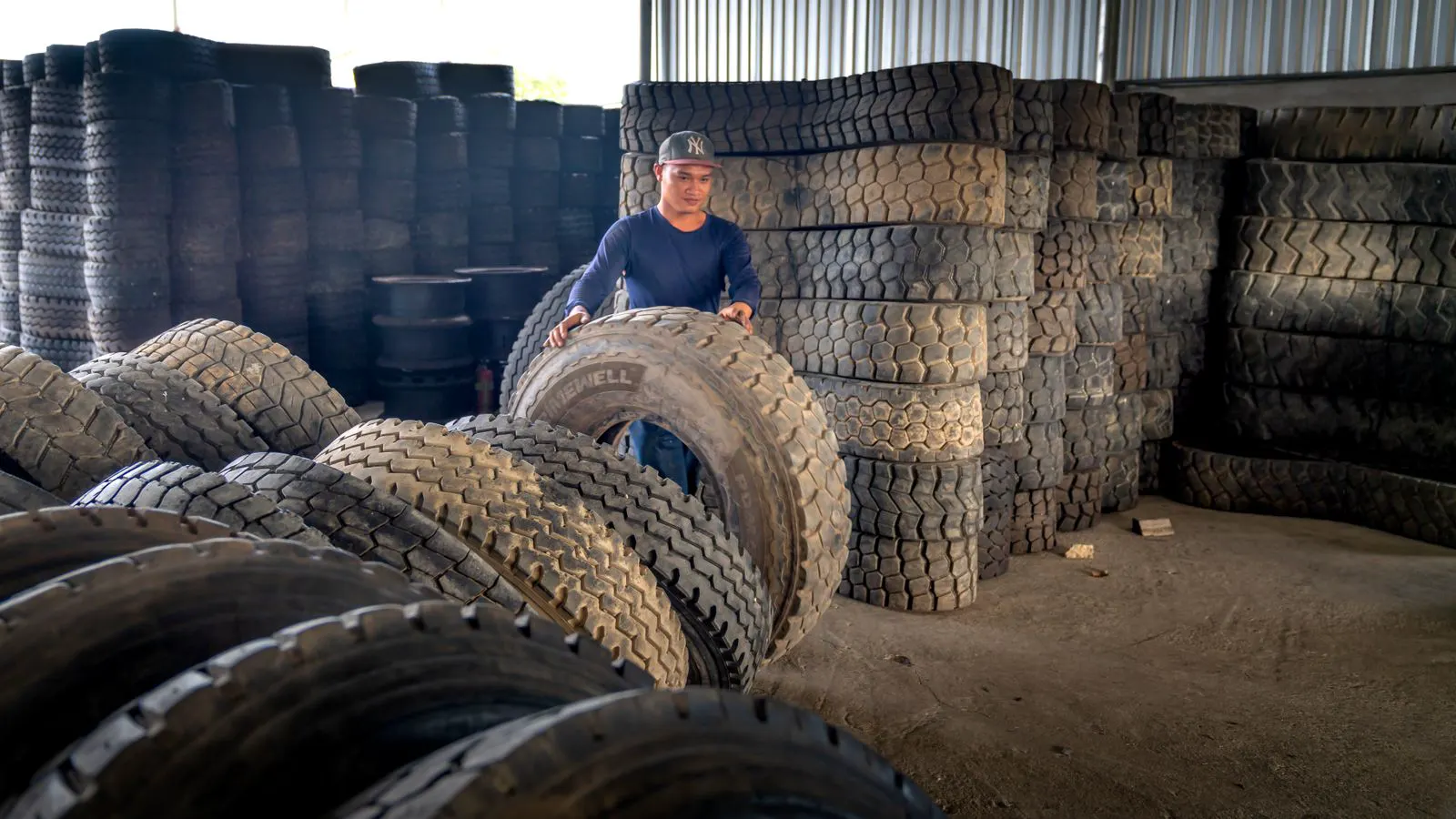 A busy warehouse dock with pallets of tires waiting for shipment