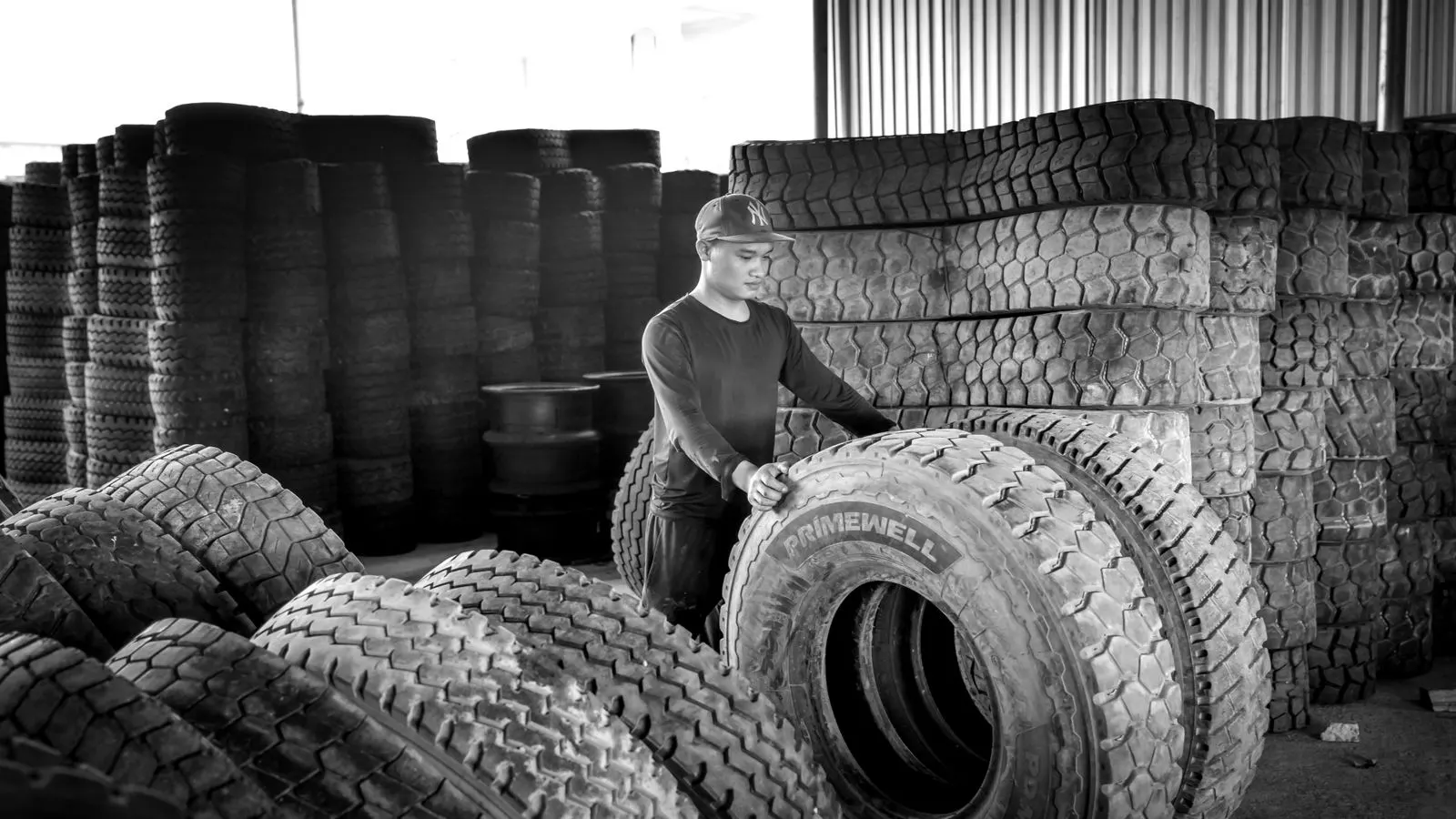 Tires stacked on metal racks inside a large warehouse facility