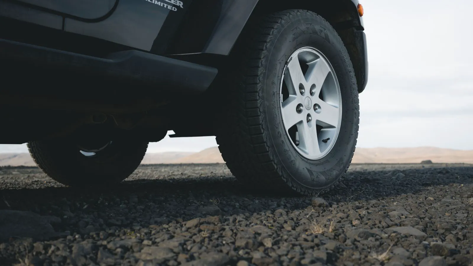 Heavy industrial tires with deep tread patterns on a rugged vehicle