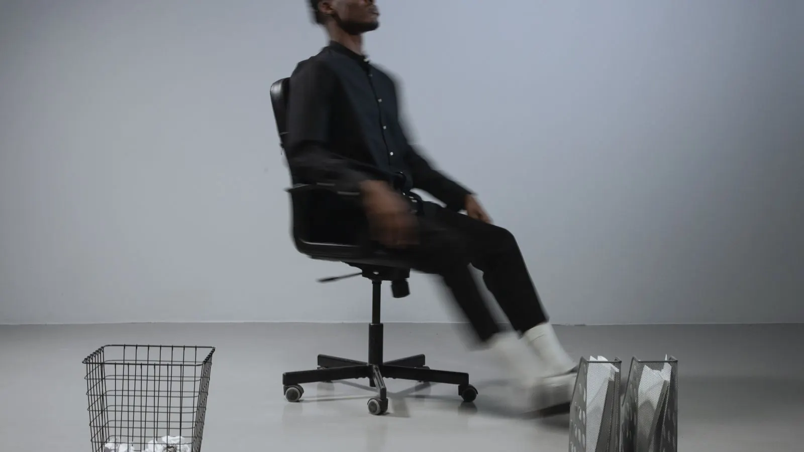 Two office chairs positioned side by side on a light concrete floor.