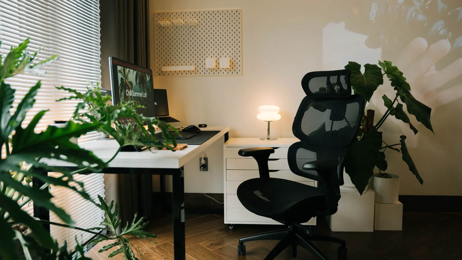 A modern ergonomic office chair sits on an assembly line.