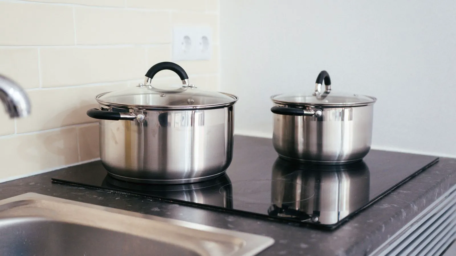 Stainless steel pots being welded in a manufacturing facility