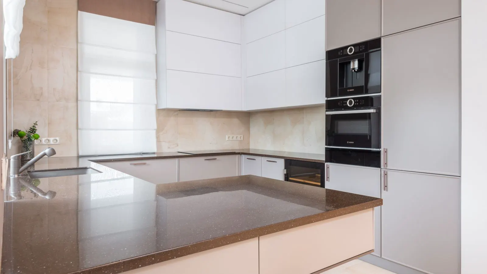 Two small kitchen appliances sit side by side on a stainless steel counter.