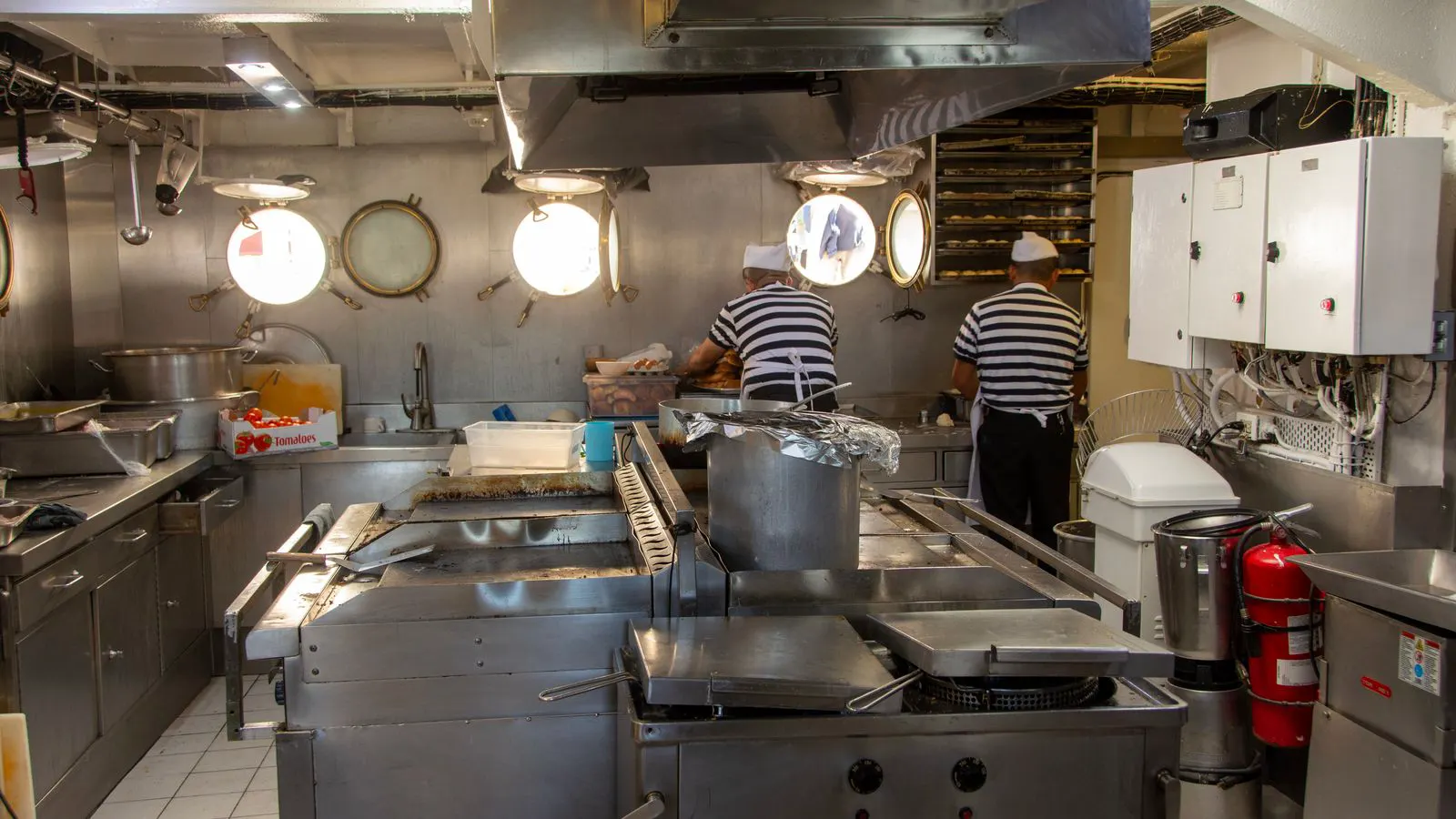 Stainless steel ventilation duct running along a kitchen ceiling