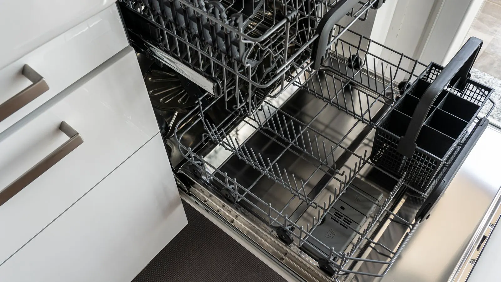 A stainless steel floorstand dishwasher installed in a commercial kitchen