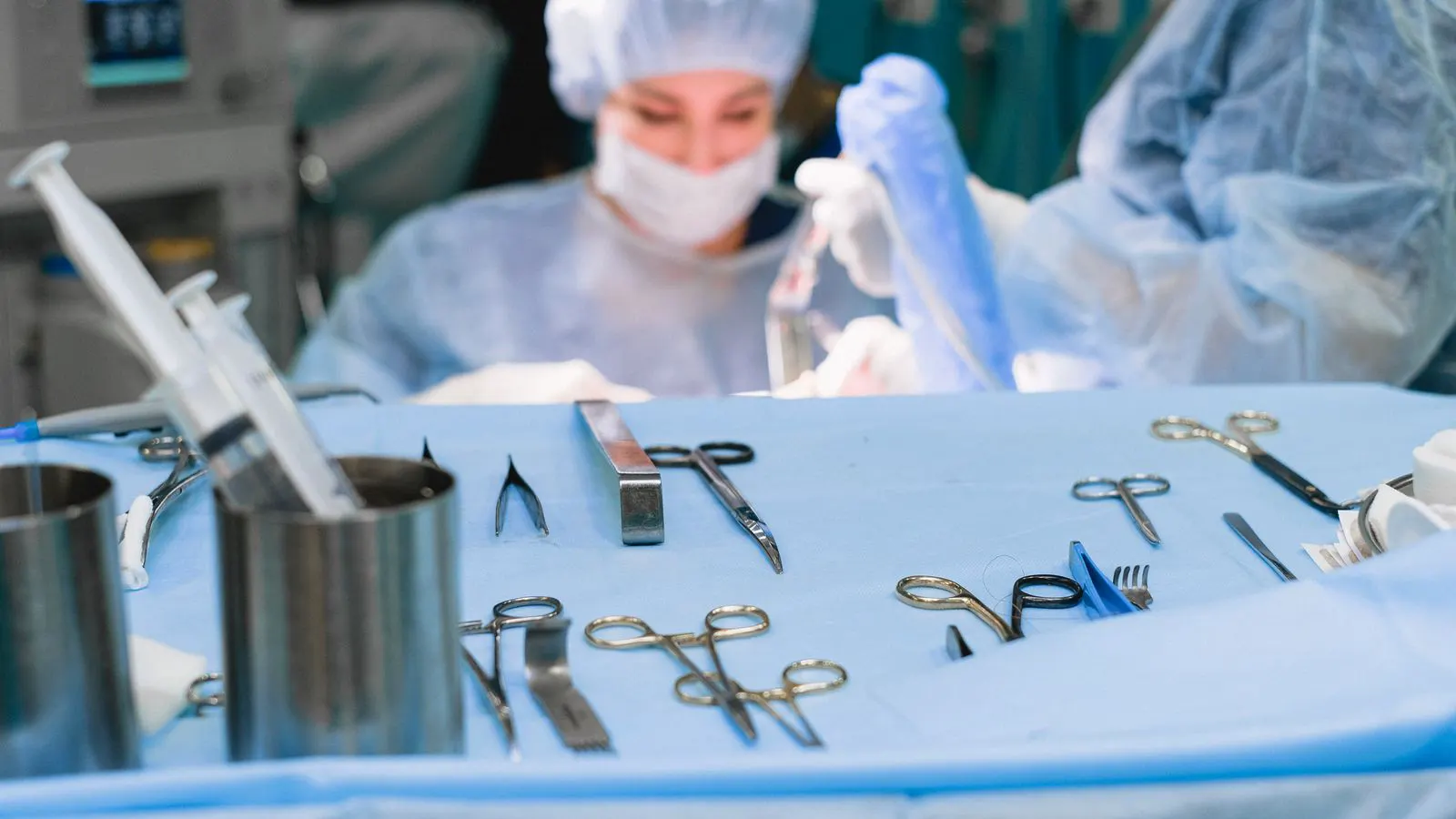 Stainless steel surgical instruments arranged on a clean operating table