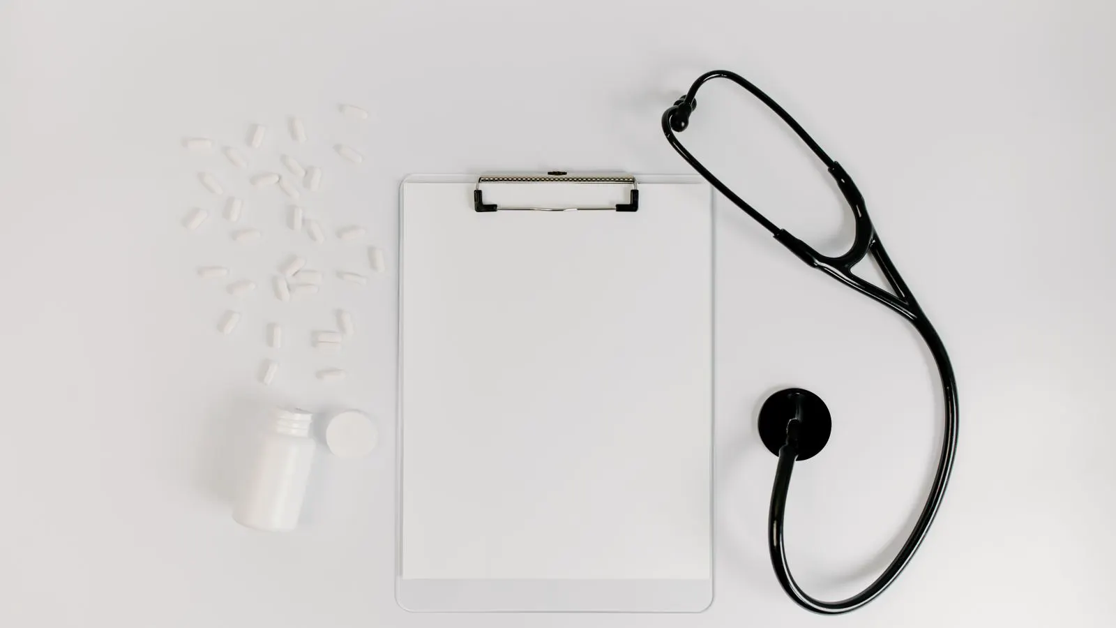 A clipboard with a printed checklist held over a production floor