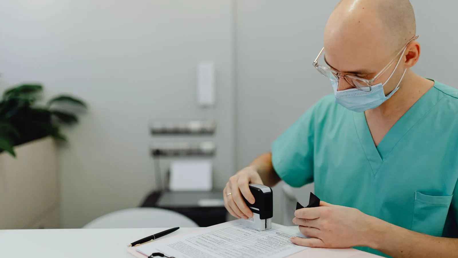 A workspace showing regulatory compliance documents and a medical device.