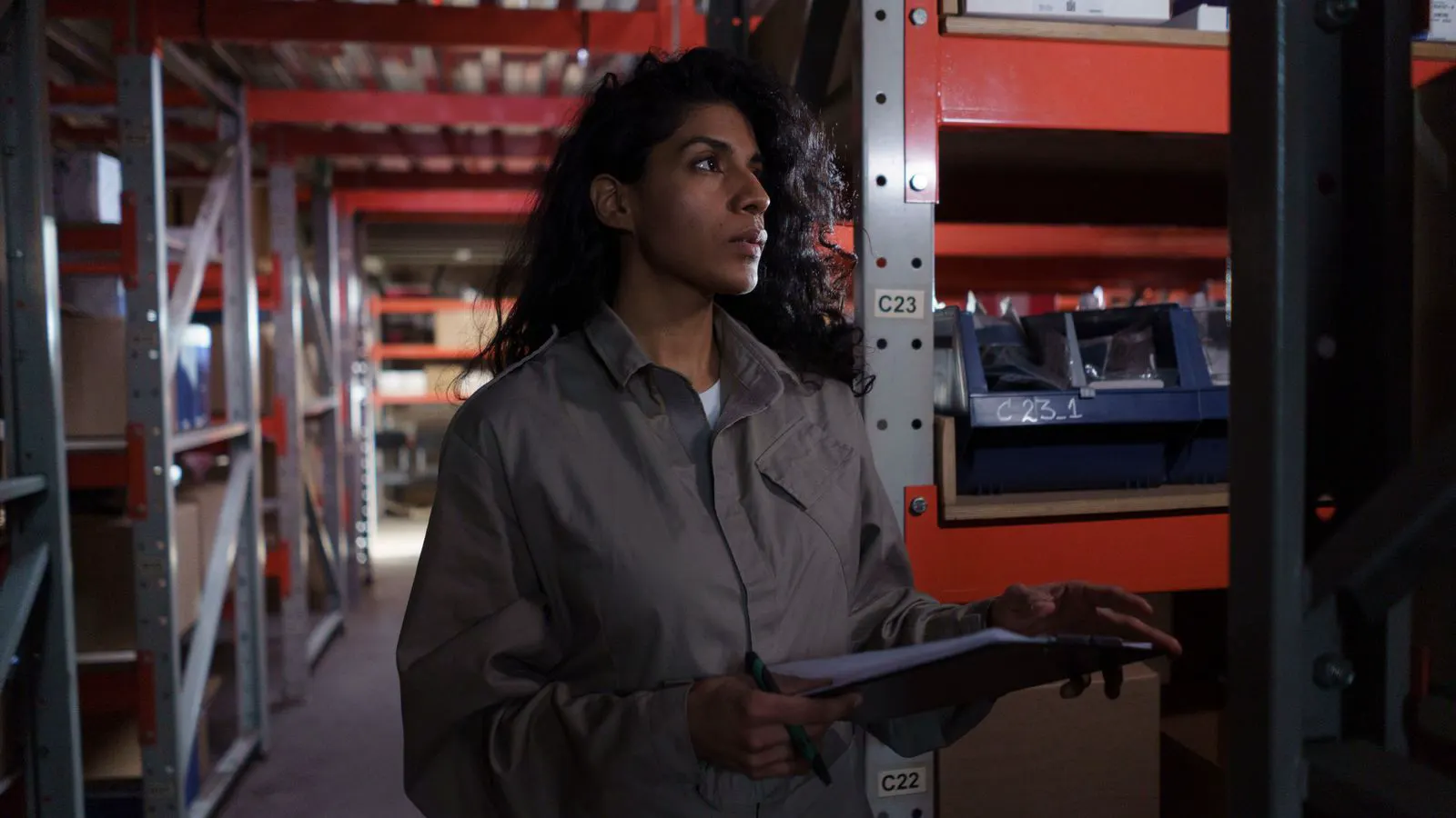 Worker examining a medical consumables carton for label errors