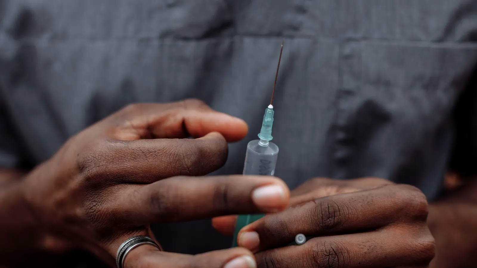 A medical syringe with a Luer lock connector attached to a port