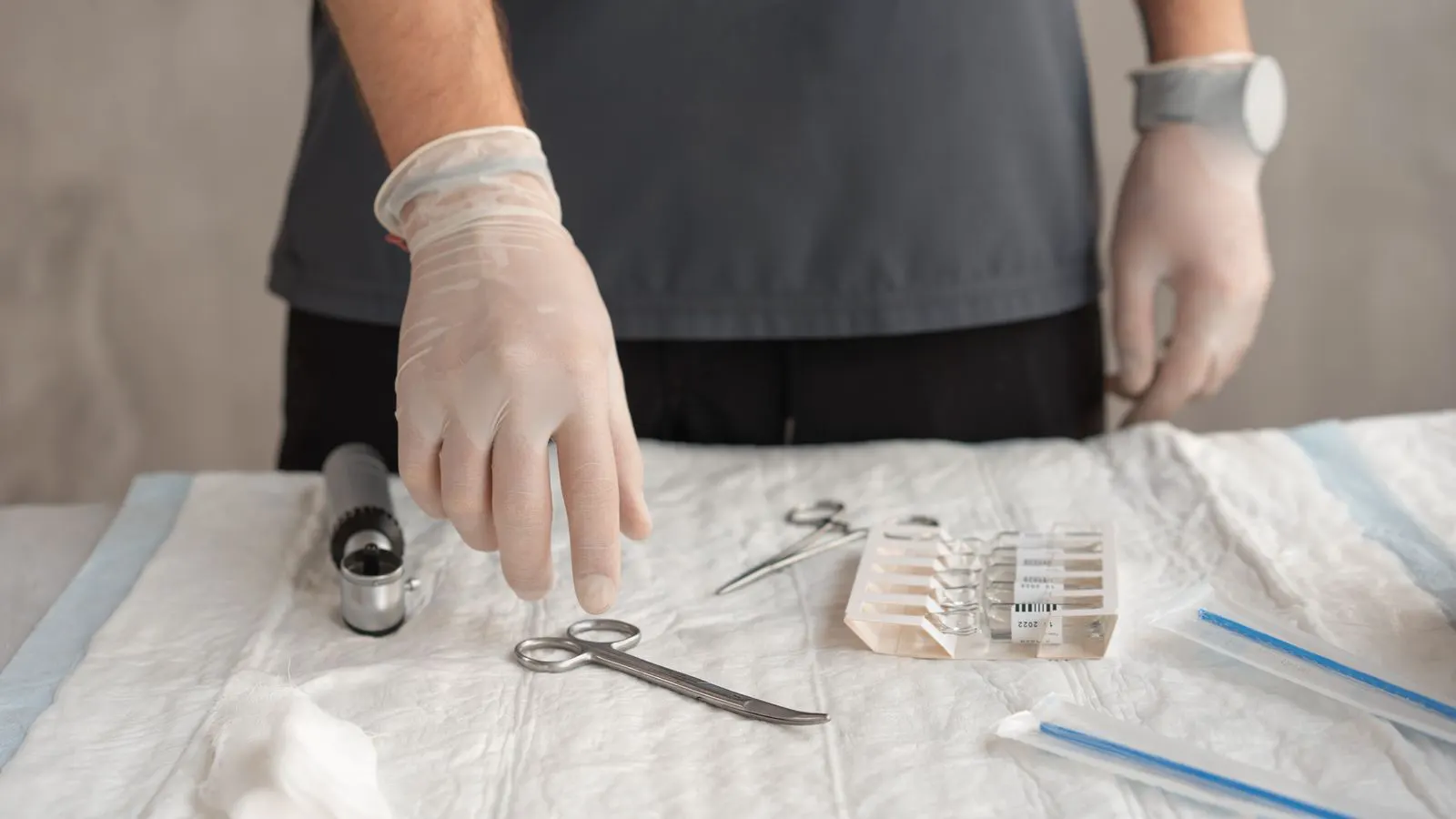 Close up of various colored disposable medical gloves on a metal tray