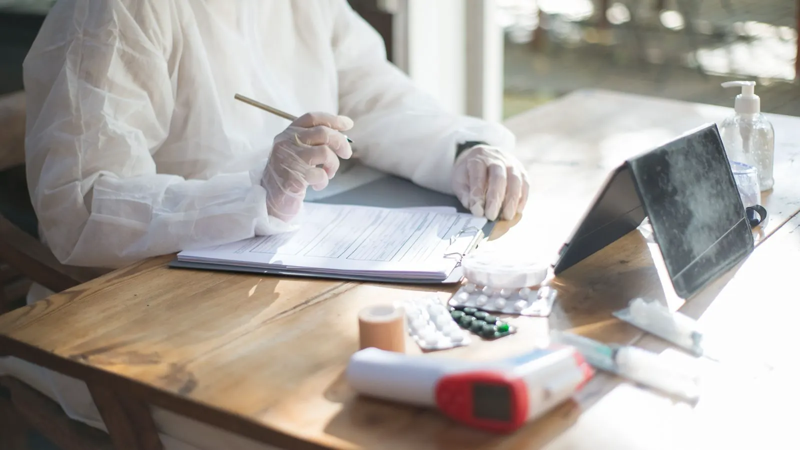 A warehouse worker scanning a serialized medical consumable package with a handheld device.