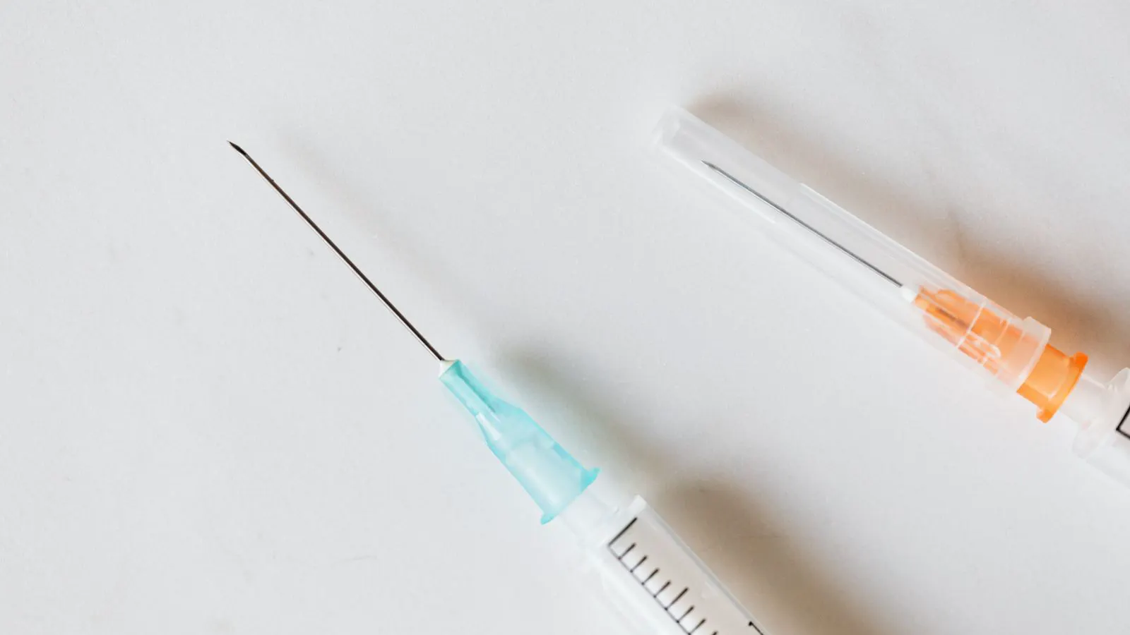 Close up of different needle sizes attached to syringe barrels