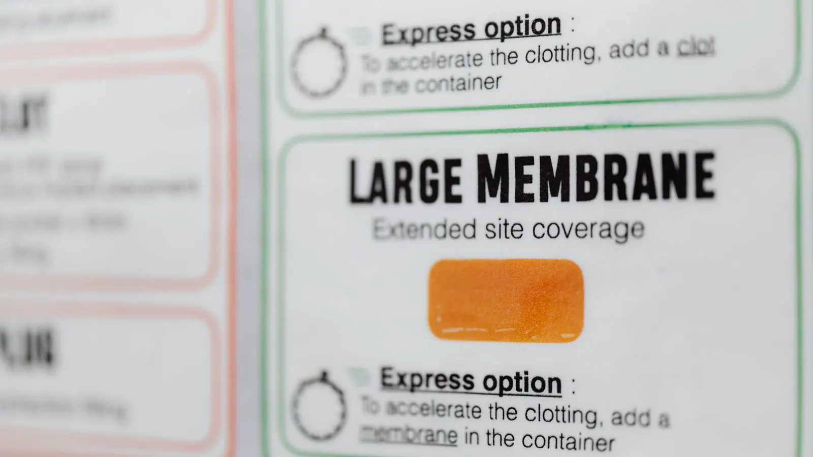 Close up of printed medical device labels and regulatory compliance paperwork on a desk.