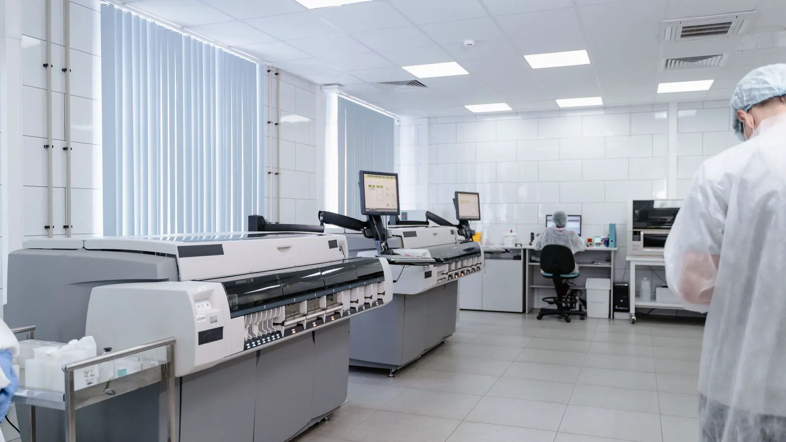 Technicians installing a fume hood in a new laboratory