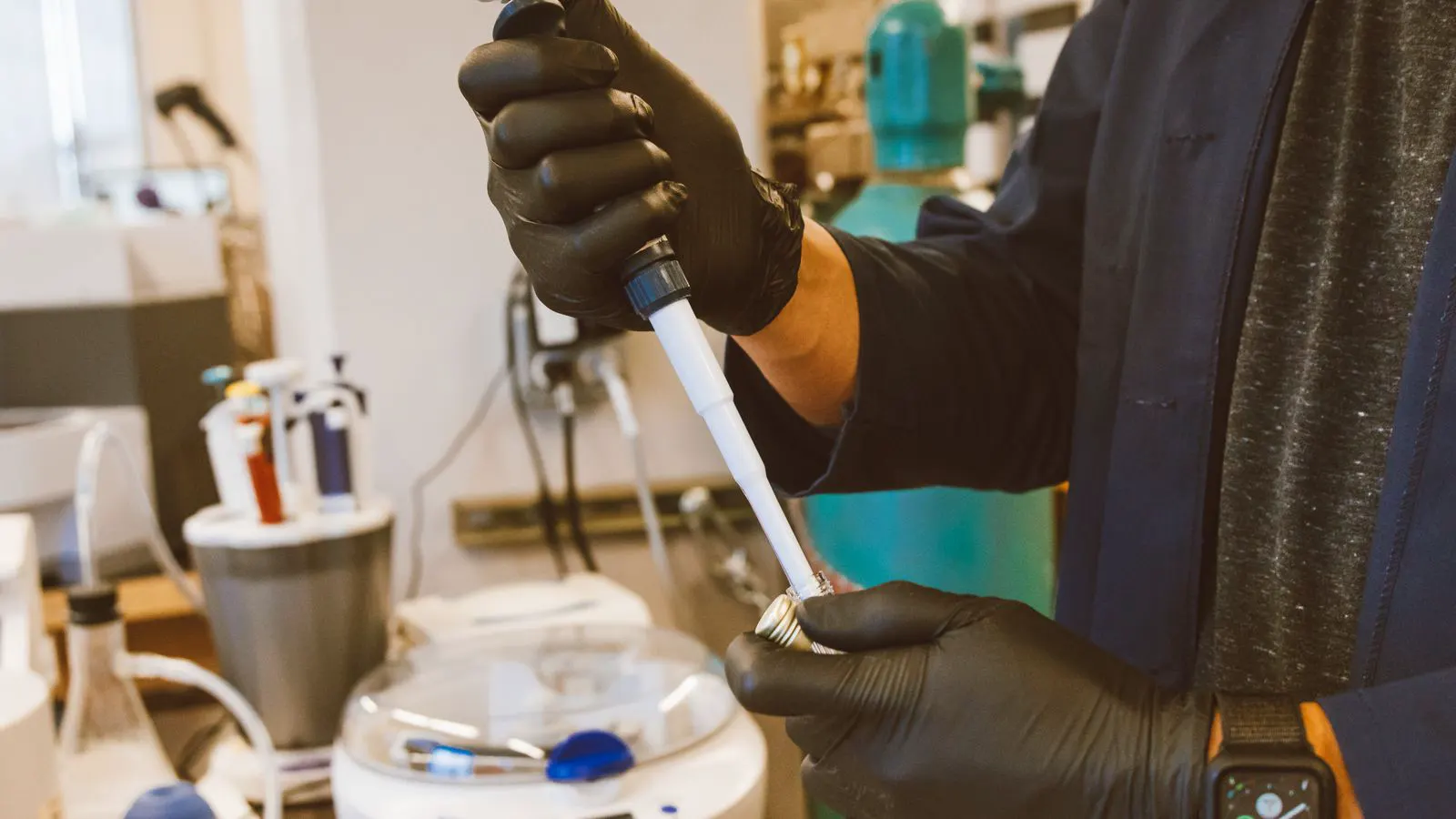 A technician uses a reference standard to check a laboratory instrument.