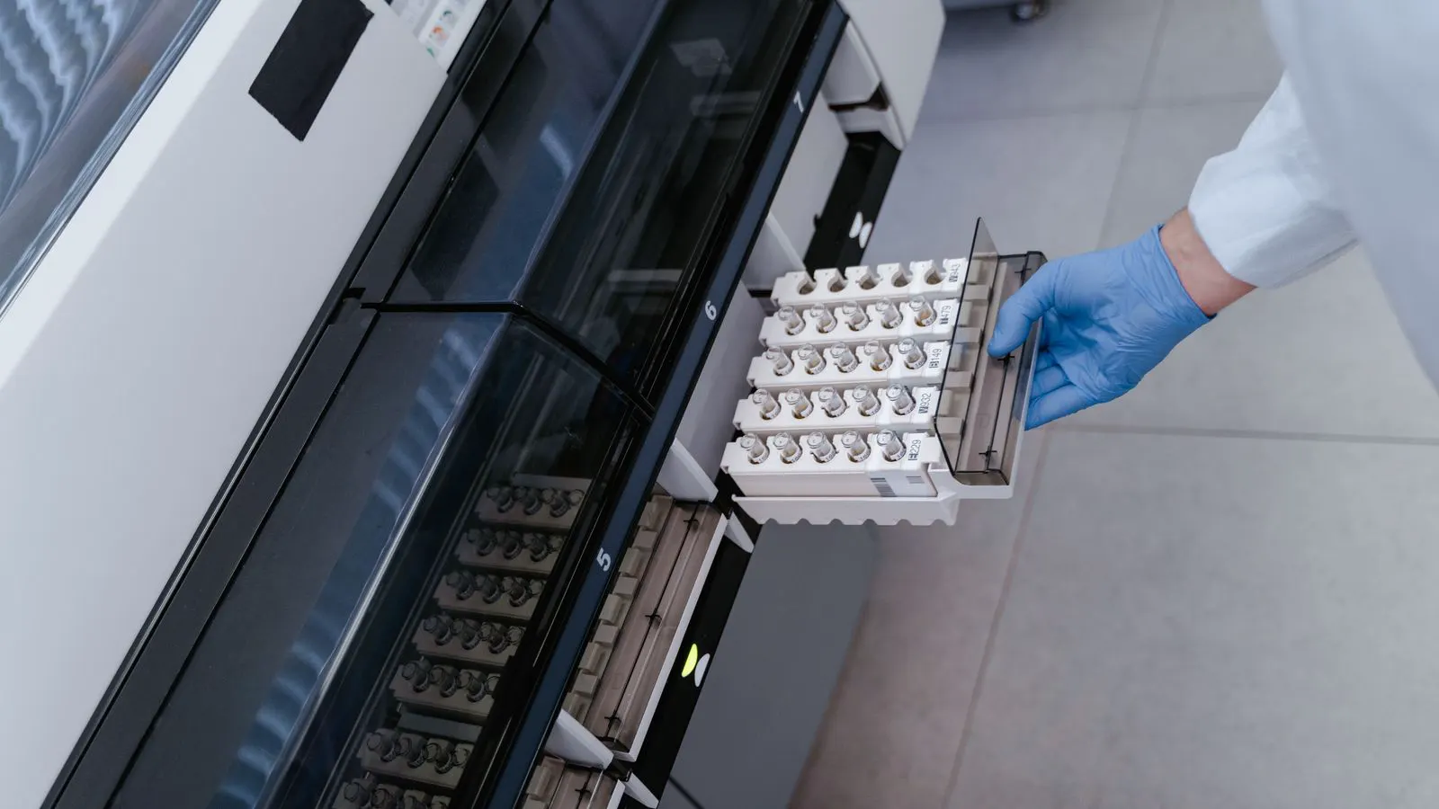 Technician checking internal components of a benchtop analyzer