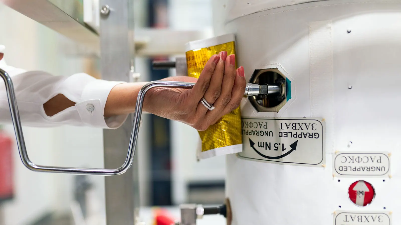 A technician checking the calibration settings on an analytical instrument.