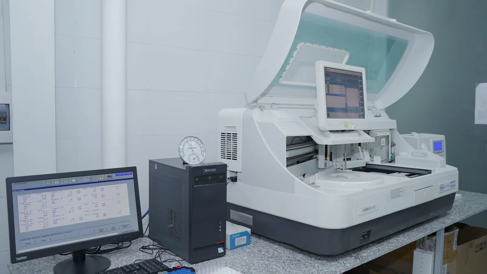 A close-up view of a laboratory gas chromatograph with a column tray.