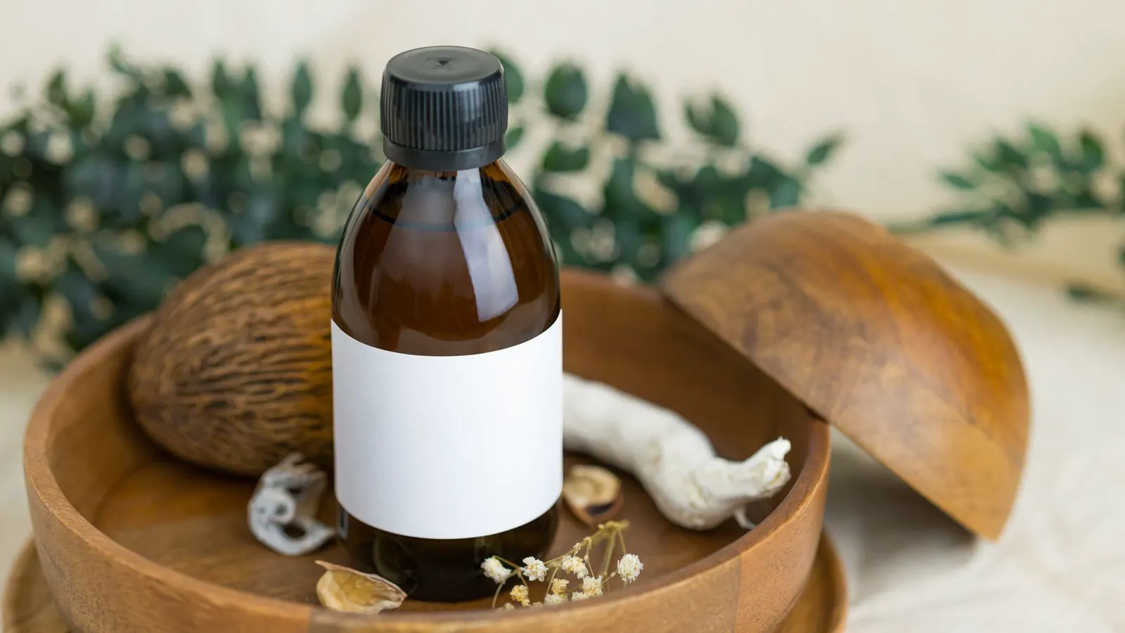 A close view of a cosmetic bottle being affixed with a printed label.