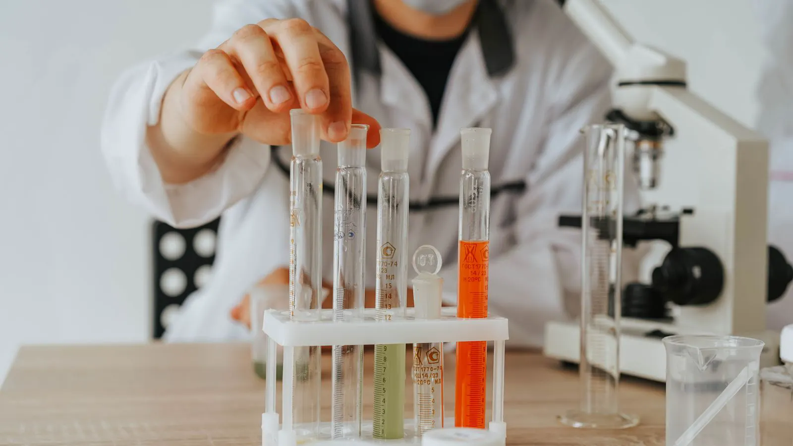 A laboratory bench showing glass vials and a beaker of liquid product