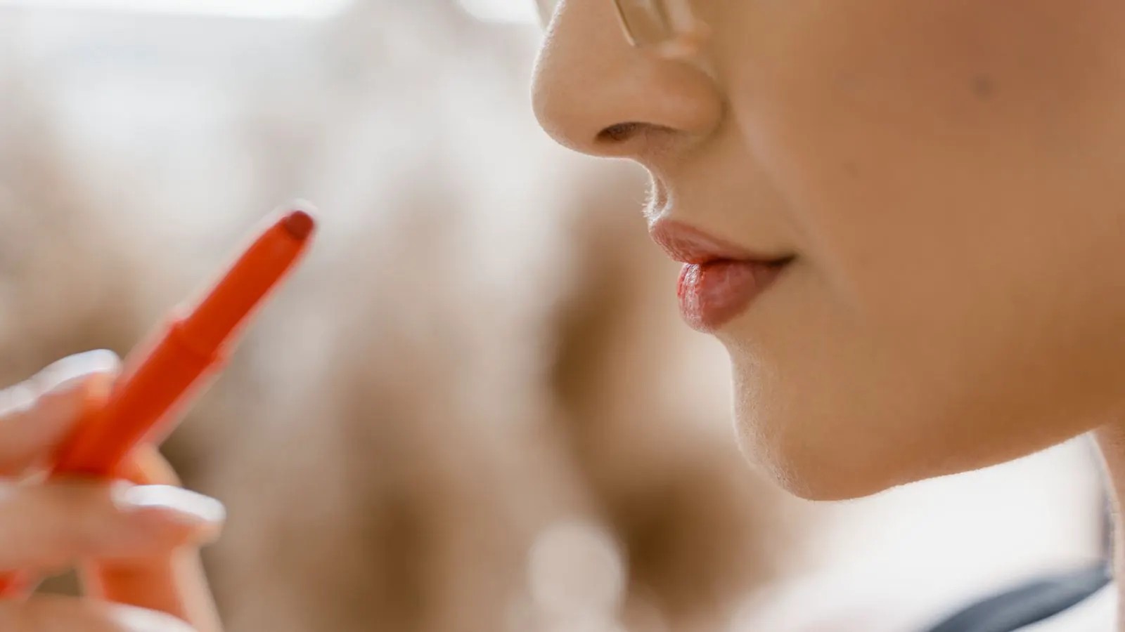 Lab technician checking pigment dispersion in a small glass vial