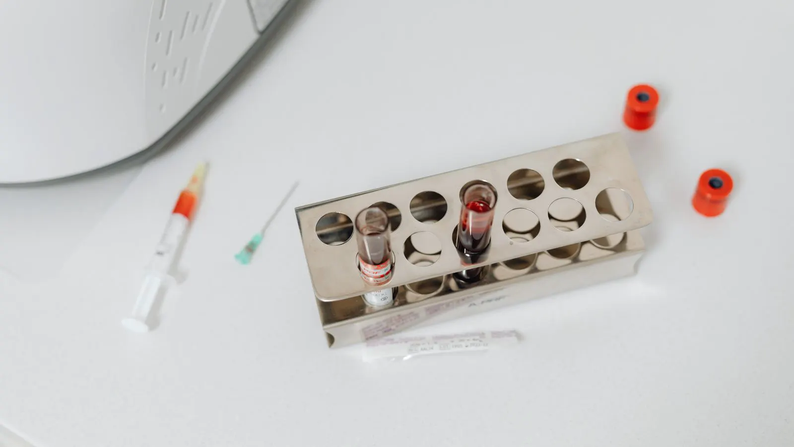 A laboratory bench with small glass vials and test tubes arranged for stability testing.