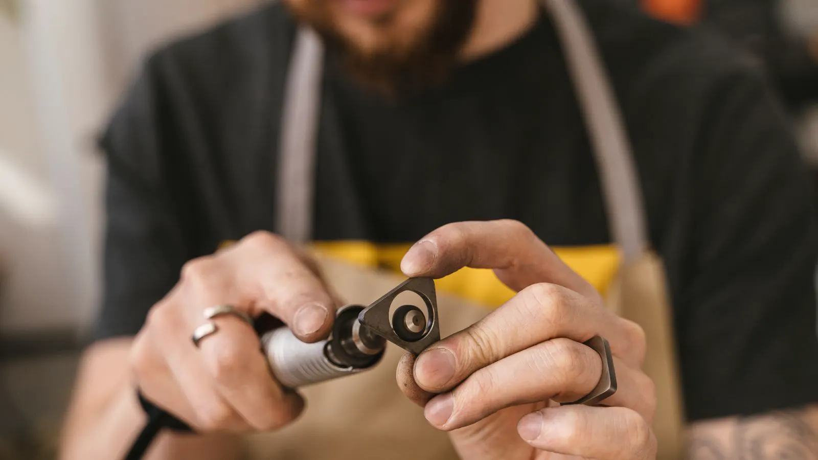 A technician checking the oil level on an industrial rotary vane compressor.