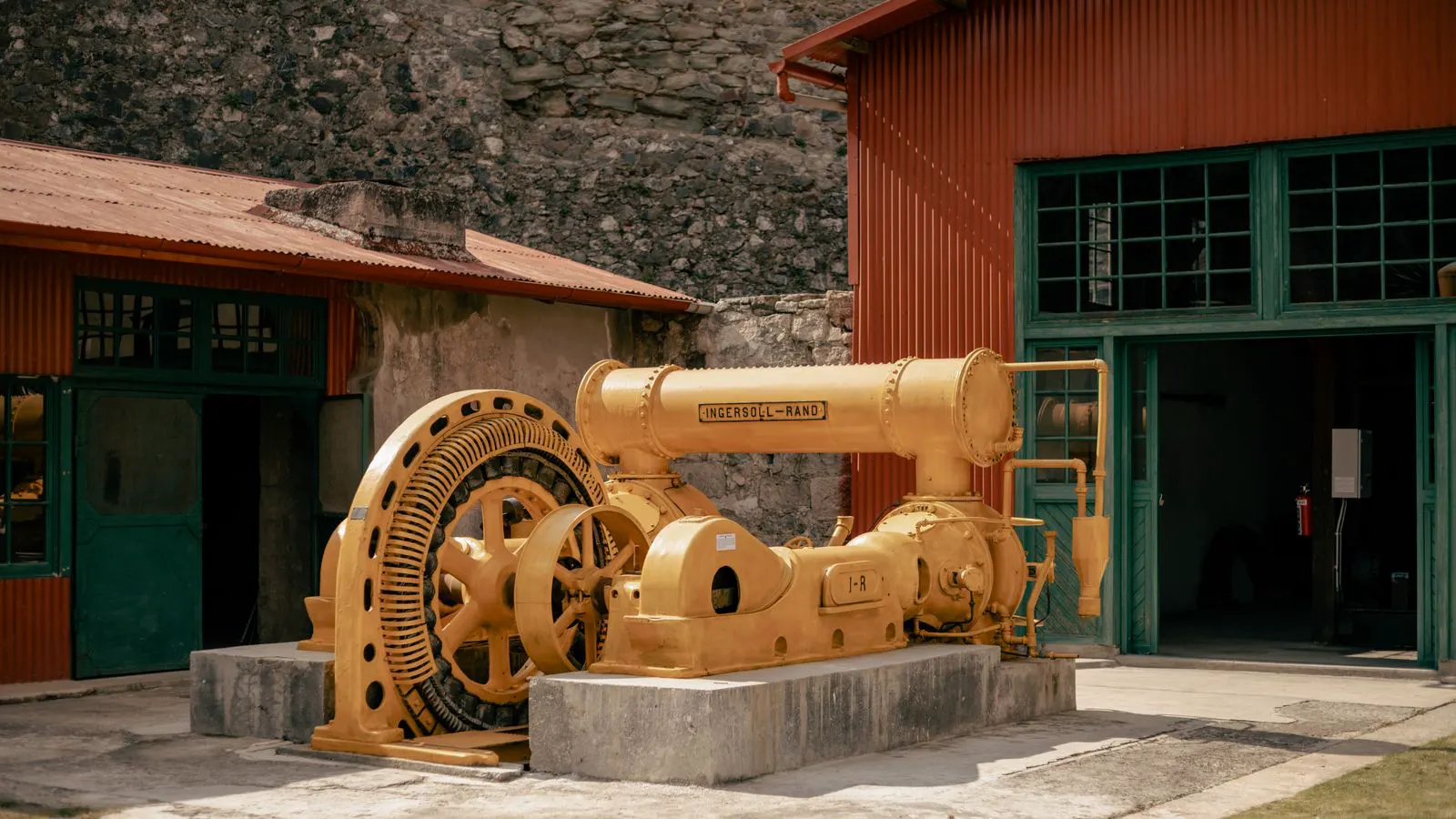 Technician inspecting an industrial air compressor unit