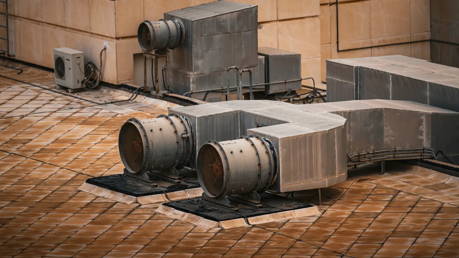 A row of industrial air compressors with attached treatment units in a clean facility