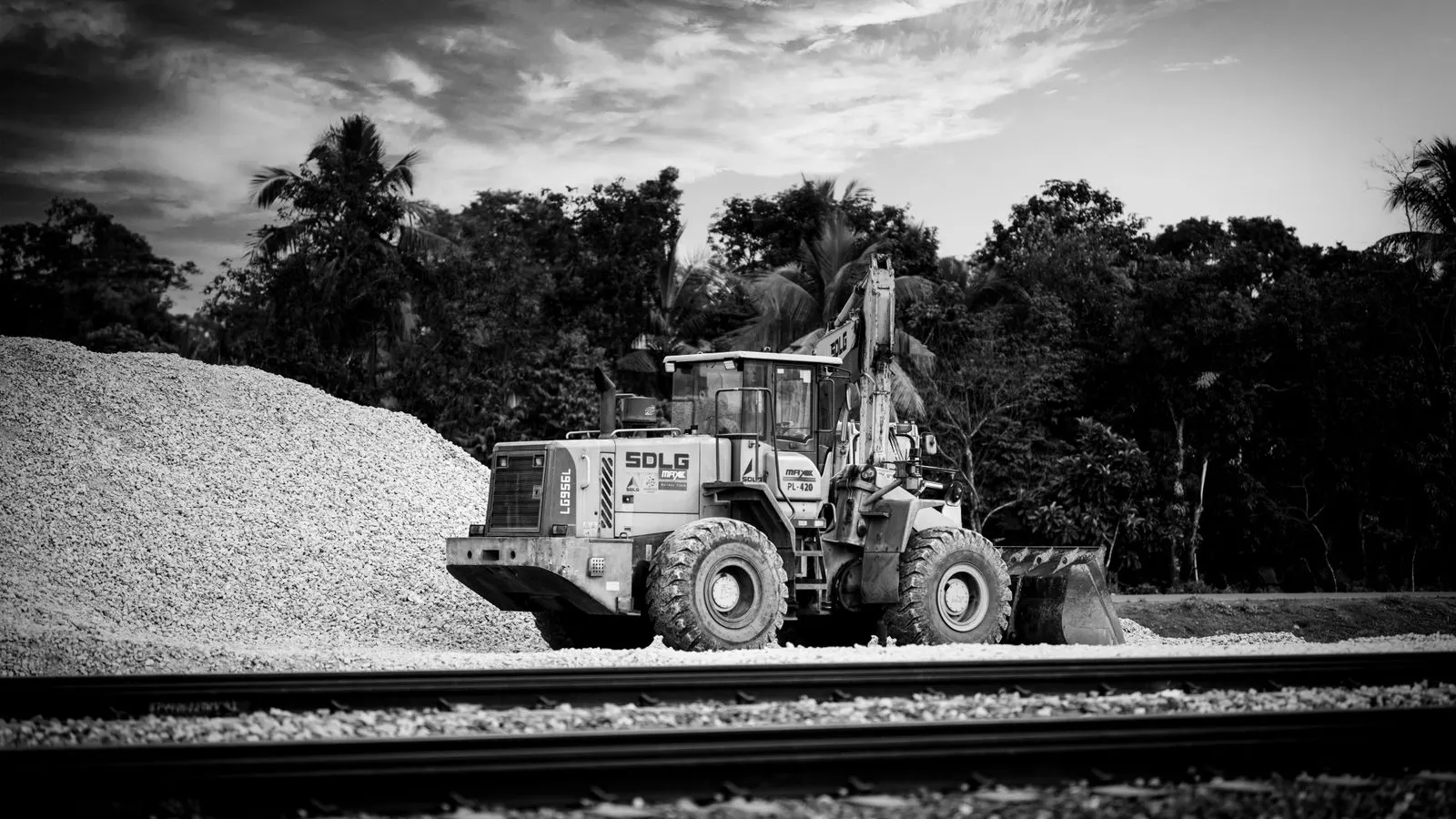 A portable diesel compressor unit sitting on a gravel pad far from infrastructure.