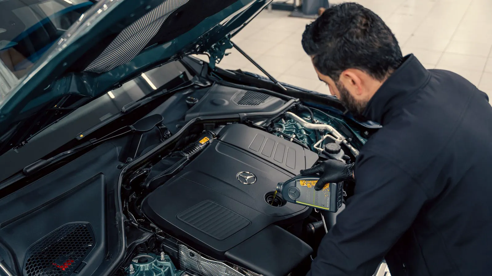 Technician checking oil filter housing during maintenance
