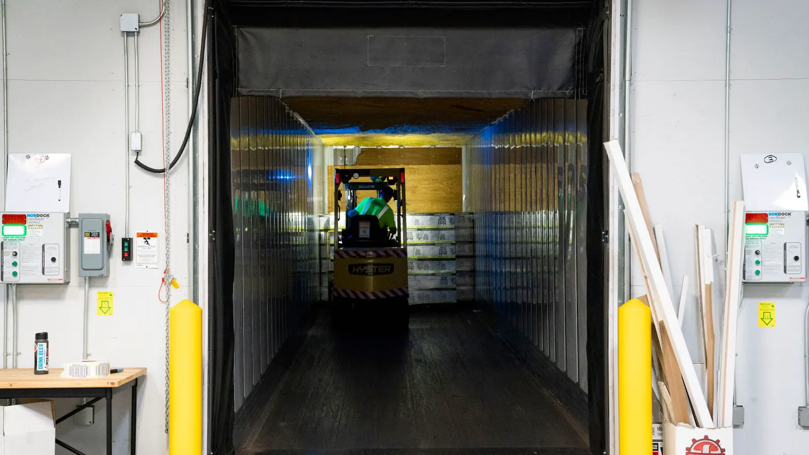 A worker checks a loading dock for an industrial compressor unit.