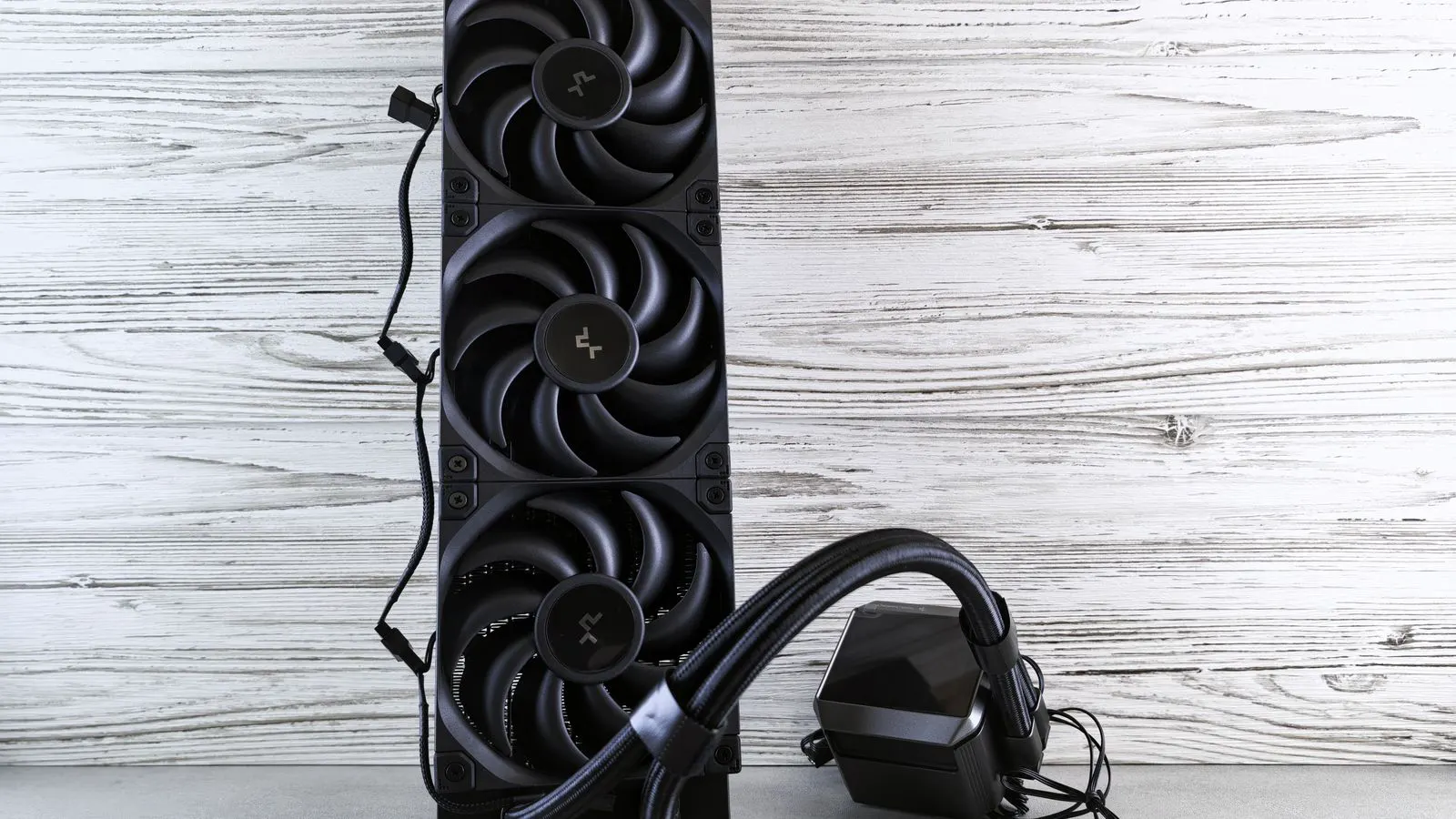 A cooling fan attached to an industrial air compressor in a workshop.