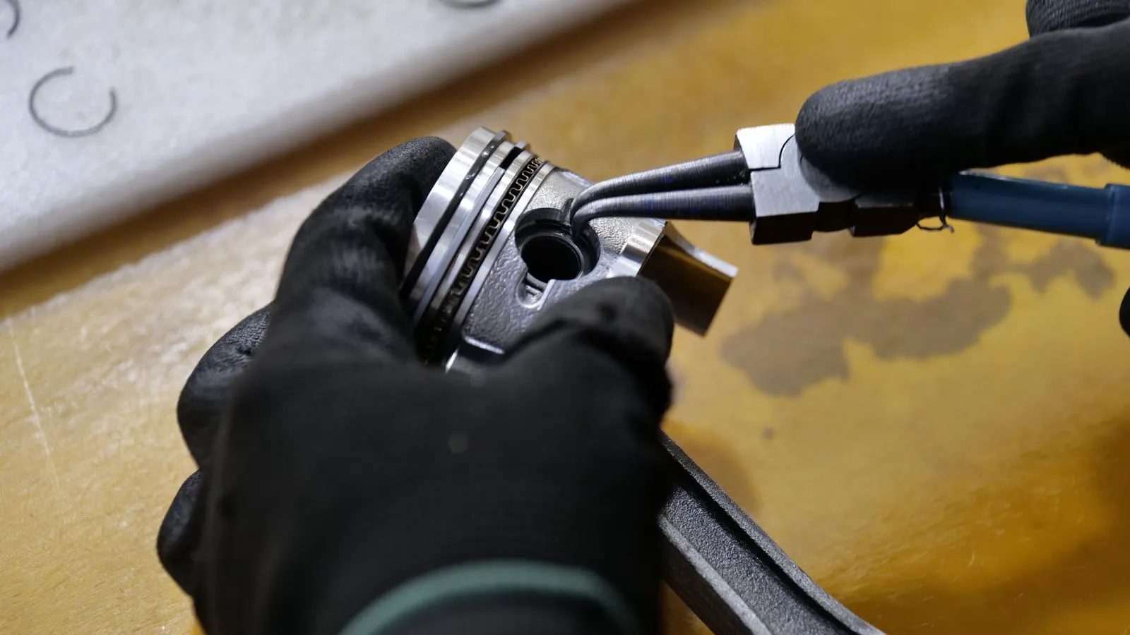 A clean industrial setting showing a multi-stage piston air compressor unit.
