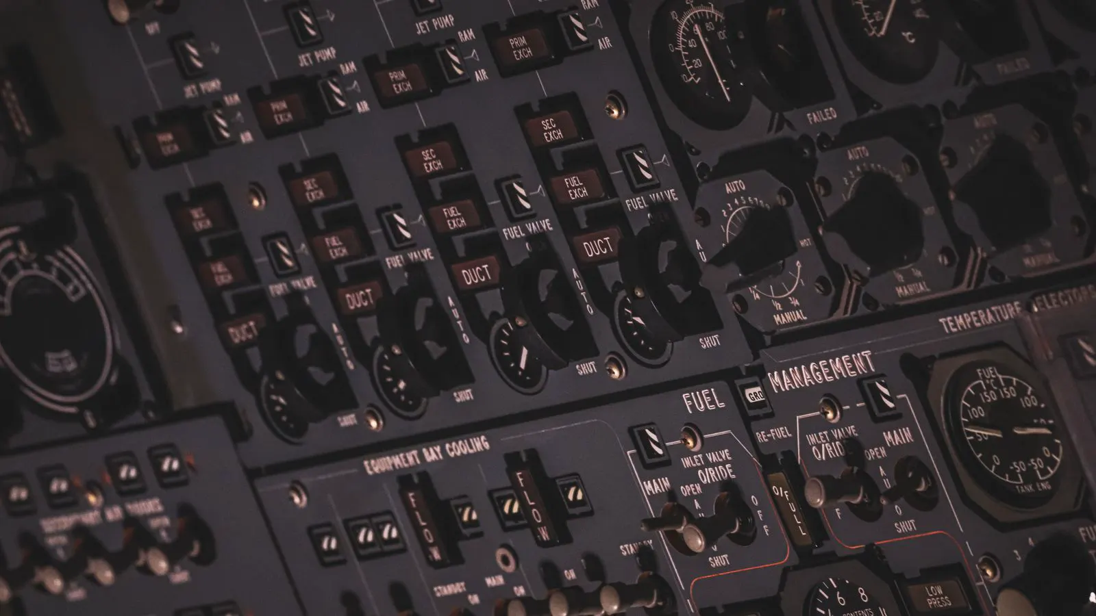 A close up view of an industrial compressor control panel with digital displays